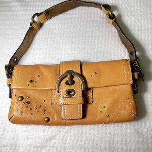 Coach leather handbag in golden tone with metal gold accent beads